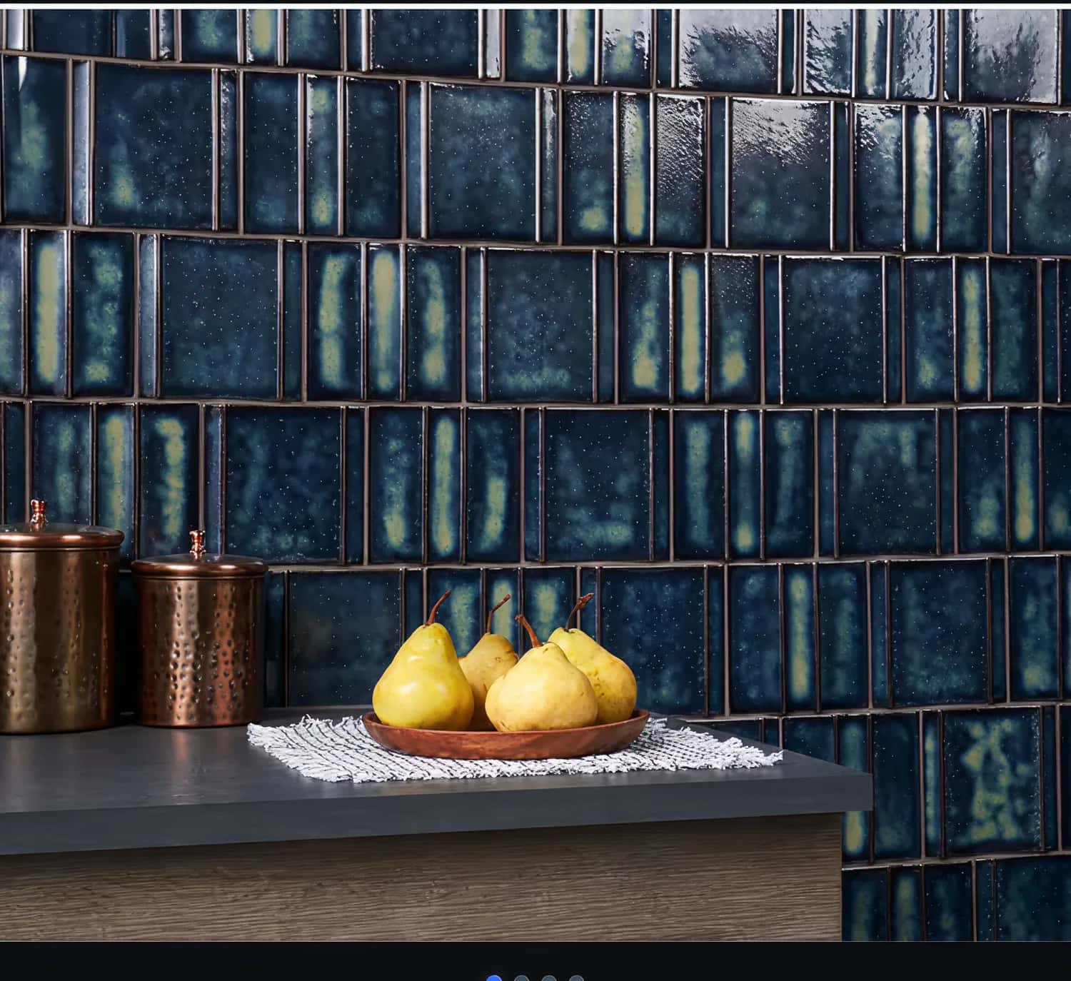 Deep blue glazed wall tiles behind a kitchen counter